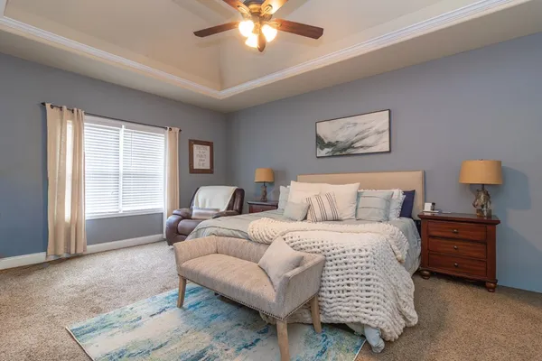 a bedroom with a bed and a chandelier
