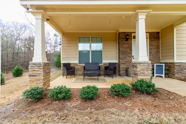 a backyard of a house with outdoor seating