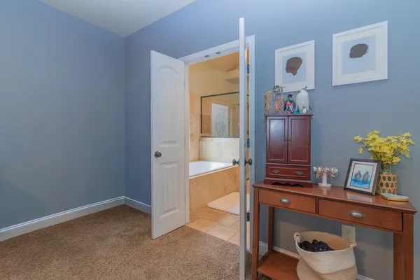 a bathroom with a tub shower and sink