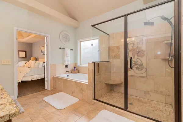 a bathroom with a granite countertop double vanity sink and a mirror