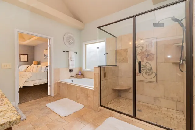 a bathroom with a granite countertop double vanity sink and a mirror