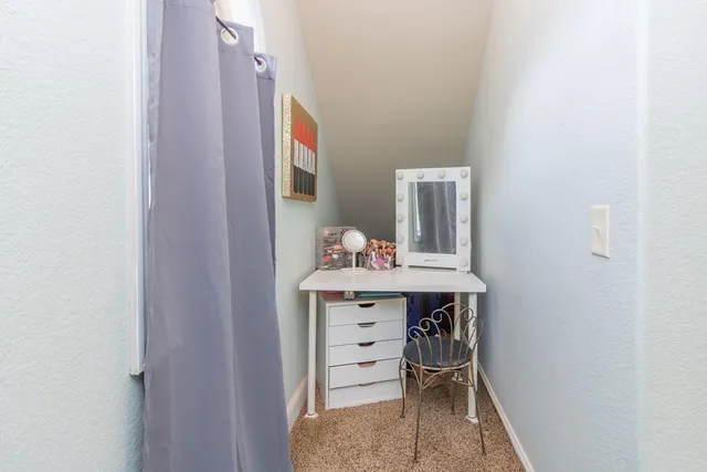 a bedroom with furniture and a flat screen tv