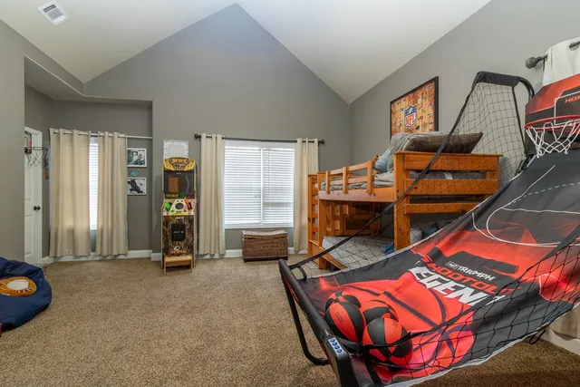 a bedroom with a large bed and a chandelier