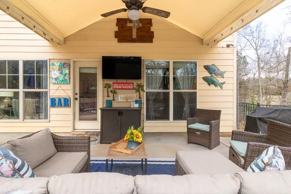a view of living room filled with furniture and flat screen tv