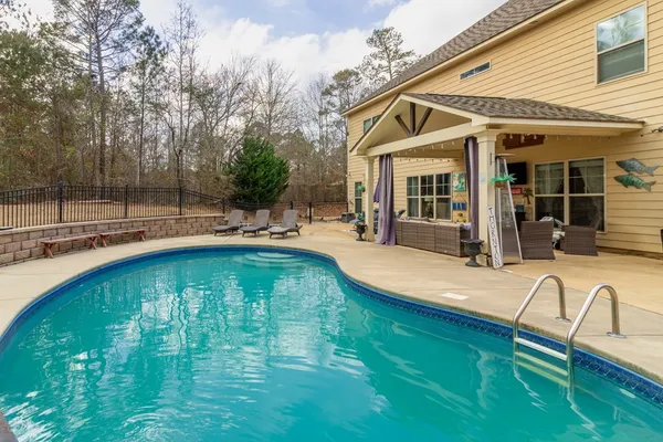 a swimming pool with patio outdoor seating
