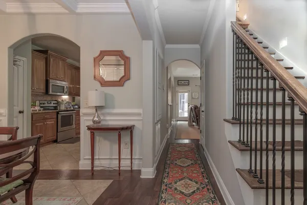 a view of a hallway with wooden floor and entryway