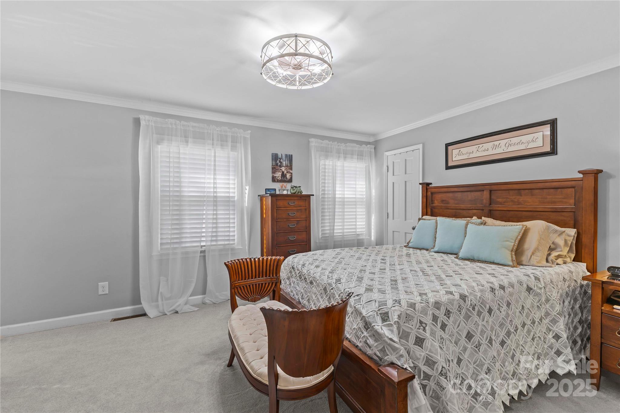 2502 Round Table Road, Unit D Monroe, NC 28110 - Photo 13 of 21 a bedroom with a bed and a chandelier
