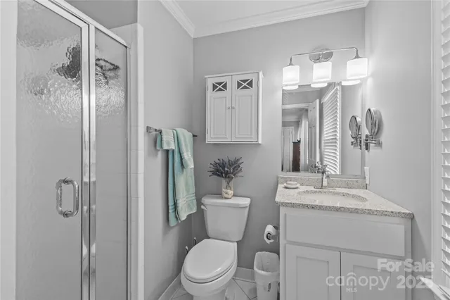 a bathroom with a toilet a sink and shower