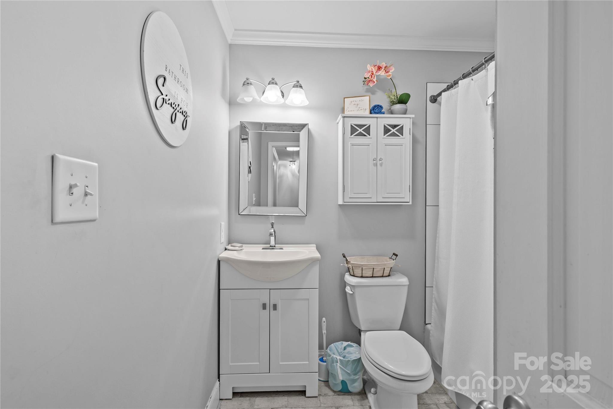 2502 Round Table Road, Unit D Monroe, NC 28110 - Photo 17 of 21 a bathroom with a toilet a sink and mirror