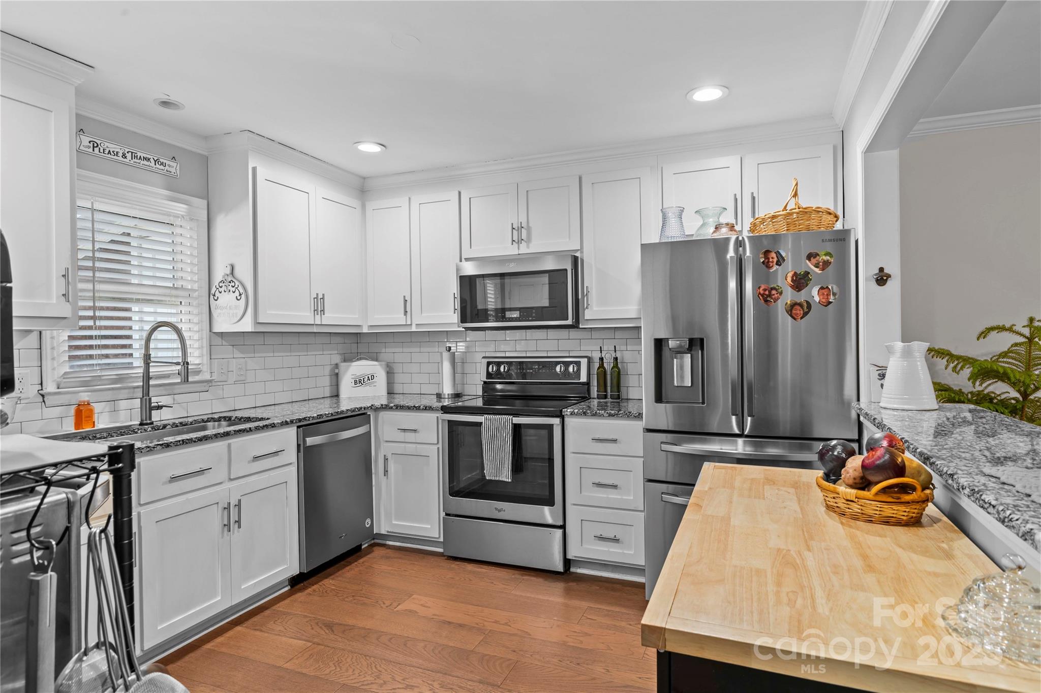 2502 Round Table Road, Unit D Monroe, NC 28110 - Photo 8 of 21 a kitchen with stainless steel appliances granite countertop a stove top oven a sink dishwasher and a refrigerator with wooden cabinets