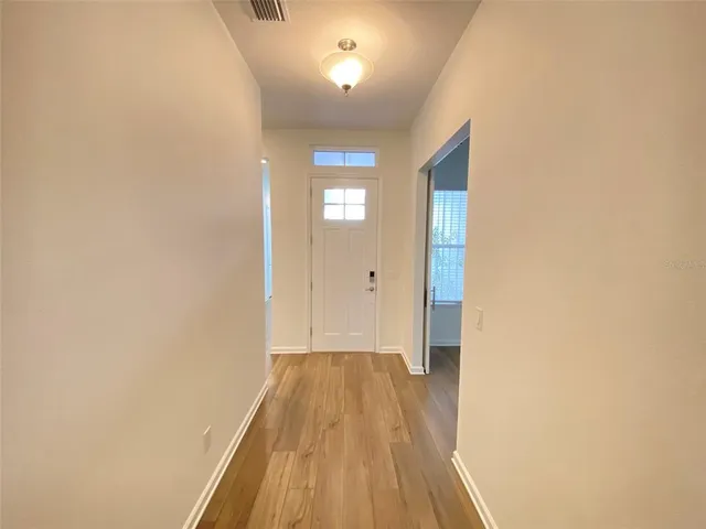 a view of a room with wooden floor and a balcony