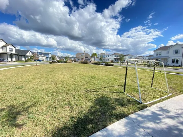 a view of chairs and table in patio with garden