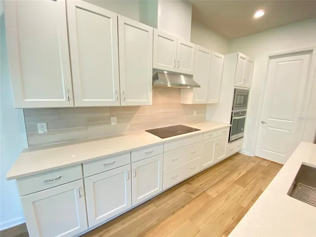 a view of a kitchen with electric appliances
