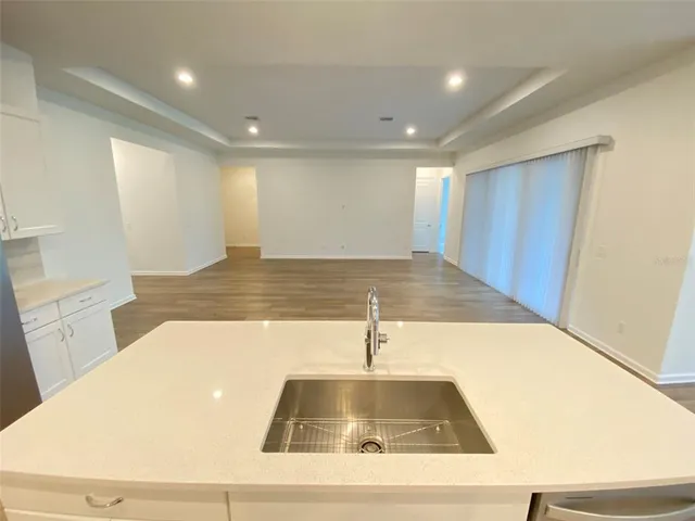 a view of a kitchen with a sink and a large window
