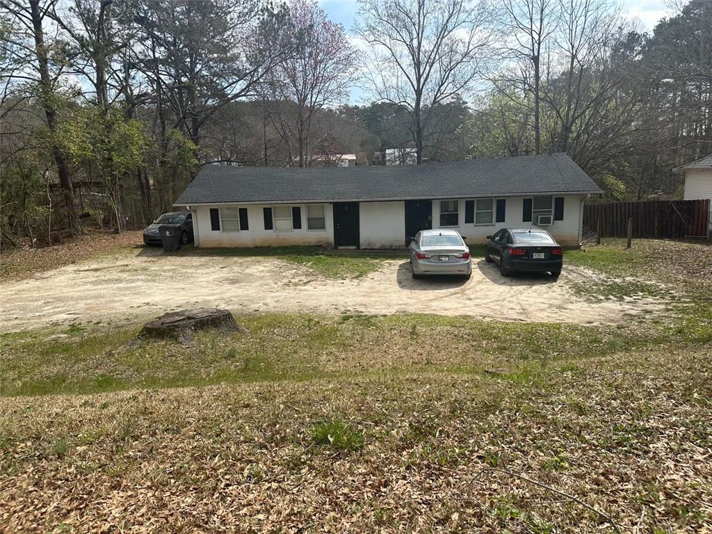 a front view of a house with yard and trees