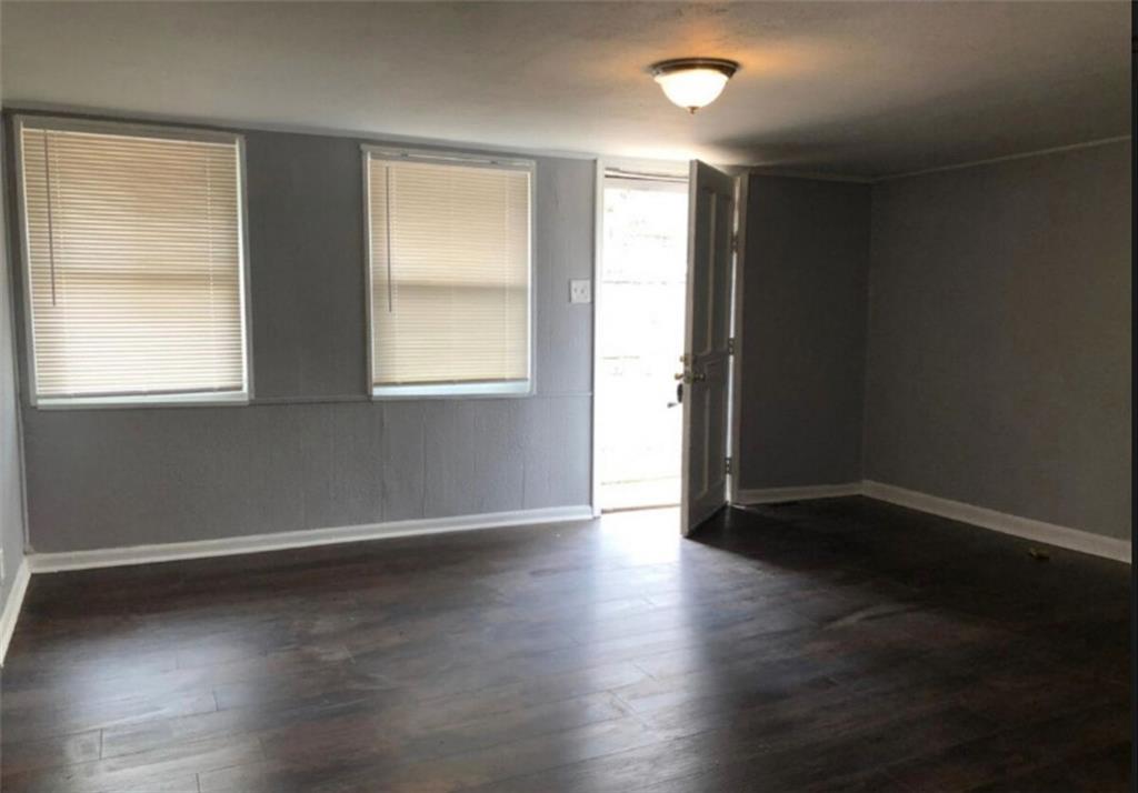 116 Lambert Drive Stockbridge, GA 30281 - Photo 2 of 8 an empty room with wooden floor and windows