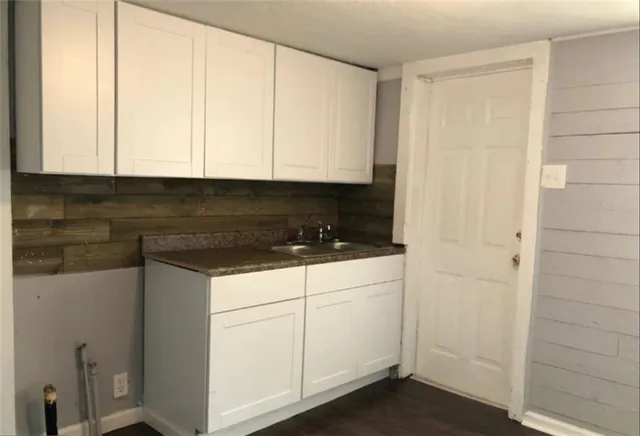 a kitchen with white cabinets and white appliances