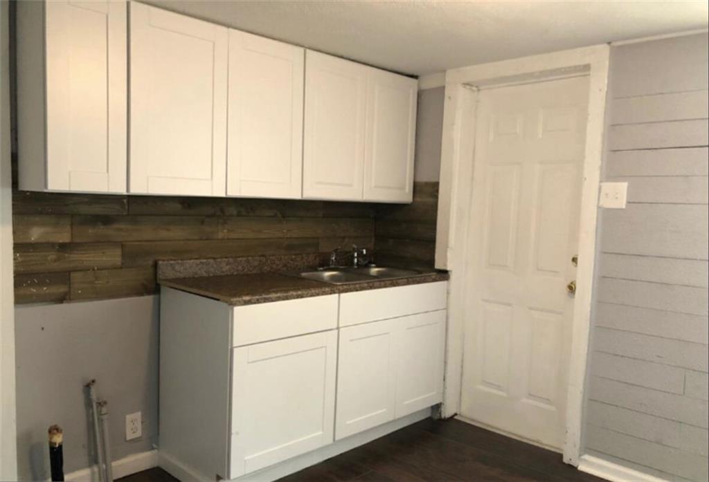 116 Lambert Drive Stockbridge, GA 30281 - Photo 5 of 8 a kitchen with white cabinets and white appliances