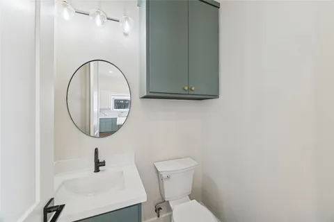 a bathroom with a toilet a sink and mirror