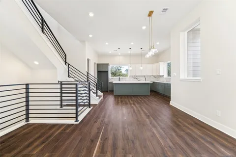 a view of kitchen and hall with wooden floor