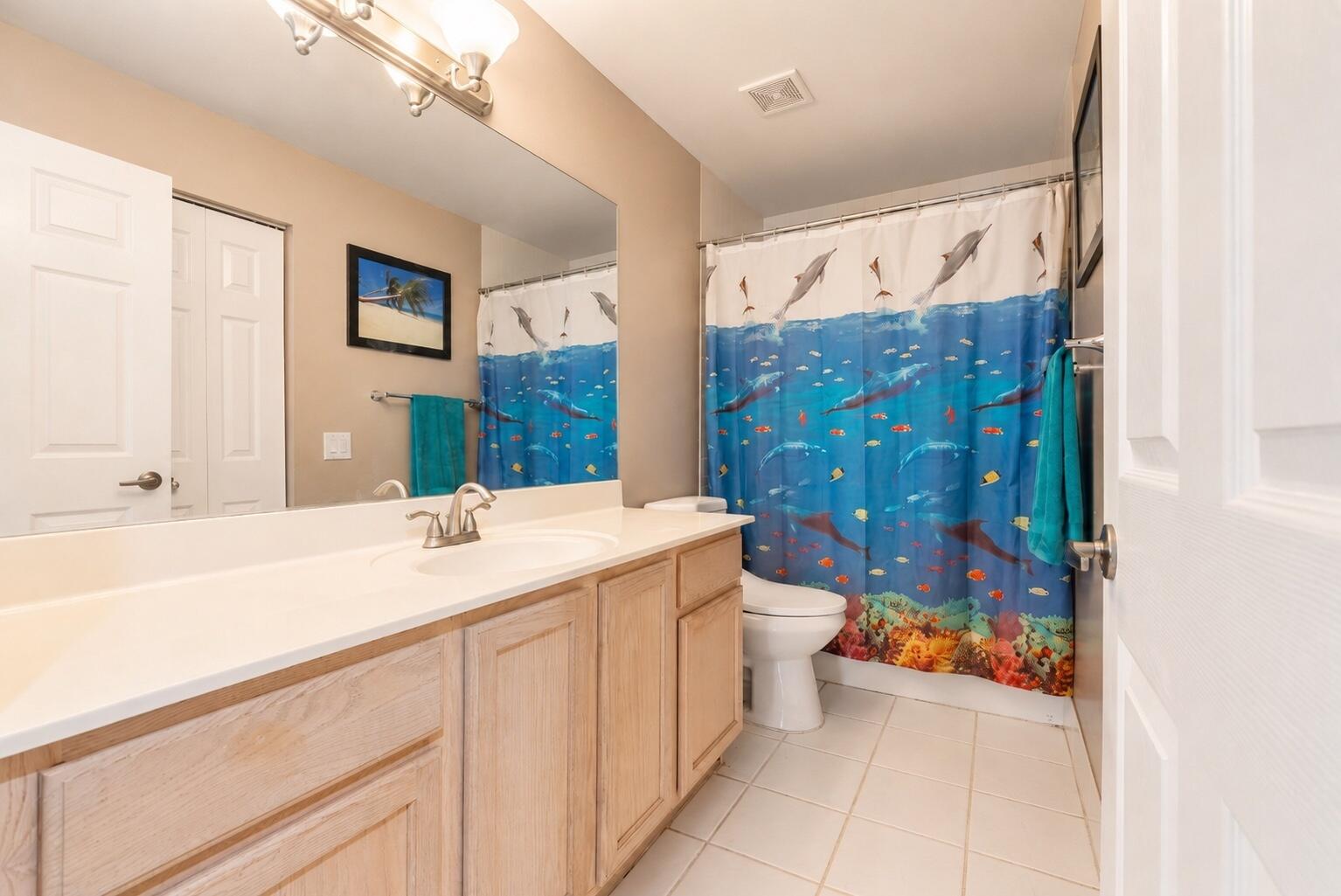 12328 St Simon Drive Boca Raton, FL 33428 - Photo 28 of 52 a bathroom with a sink a toilet a shower curtain and a large mirror