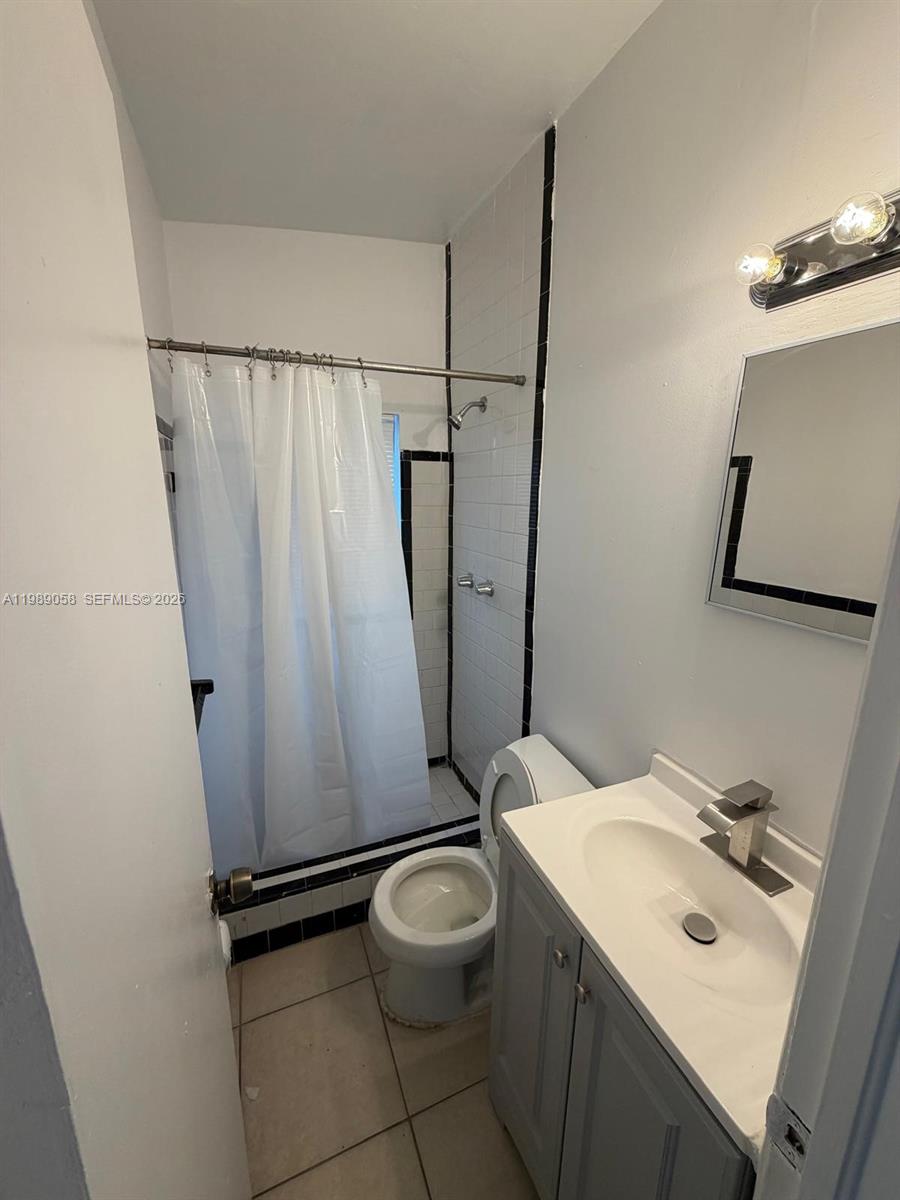 5411 Ravenswood Road, Unit 6 Dania Beach, FL 33312 - Photo 3 of 7 a bathroom with a sink toilet and shower