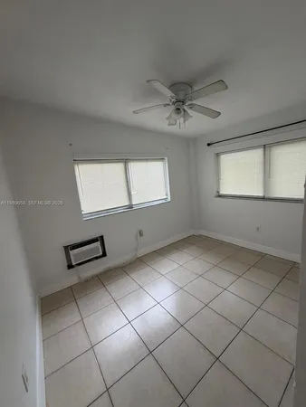 a view of an empty room with windows