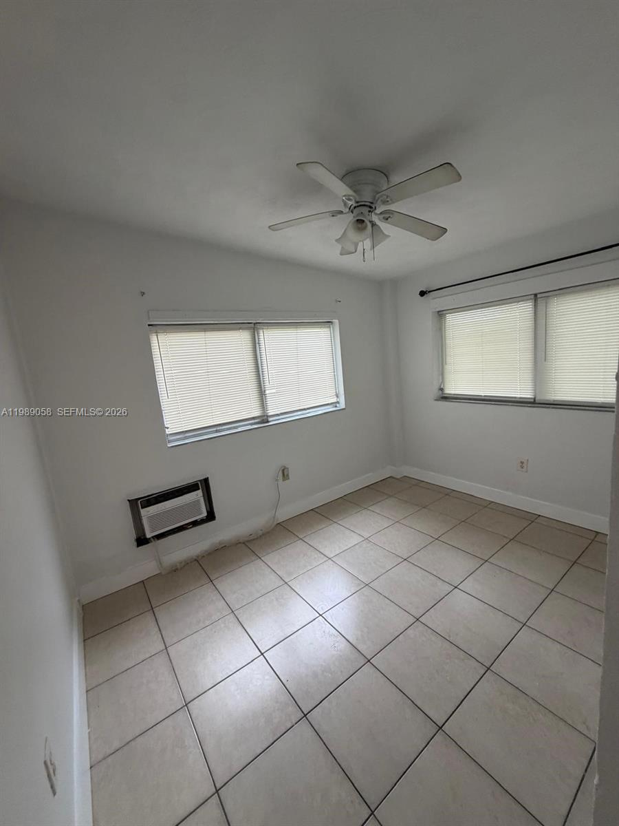 5411 Ravenswood Road, Unit 6 Dania Beach, FL 33312 - Photo 4 of 7 a view of an empty room with windows