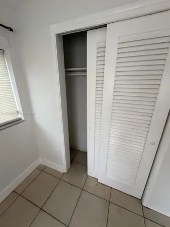 a view of storage and utility room with closet
