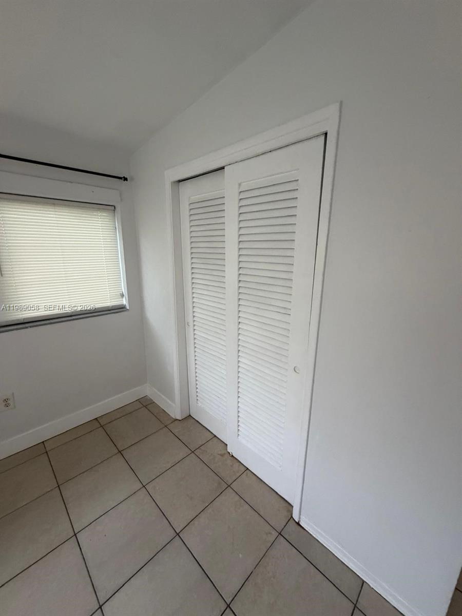 5411 Ravenswood Road, Unit 6 Dania Beach, FL 33312 - Photo 7 of 7 a view of an empty room with a window