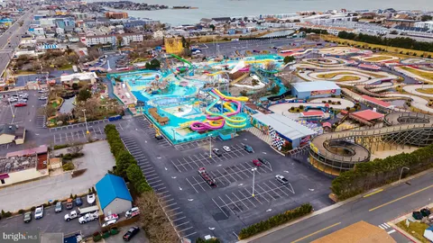 a view of house with ocean and boats in it