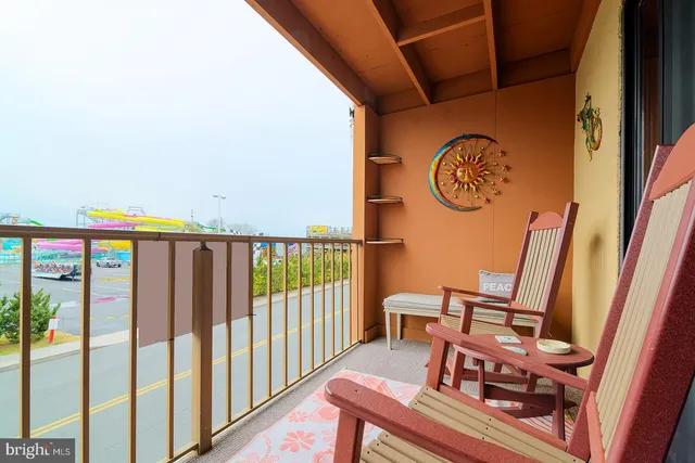 a view of a chairs and table in the balcony