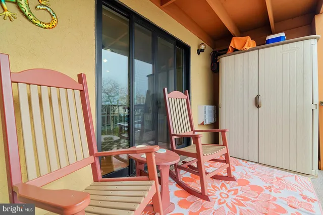 a view of a balcony with table and chairs