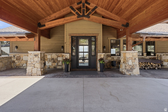 7885 North Rabbitbrush Court, Unit 13 Park City, UT 84098 - Photo 79 of 88 Covered entryway featuring natural wood ceiling and exposed timber beams with dark metal accents