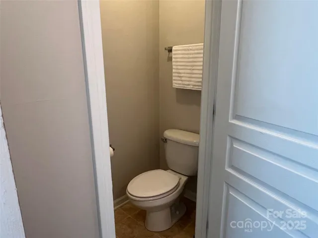 a white toilet sitting next to a shower