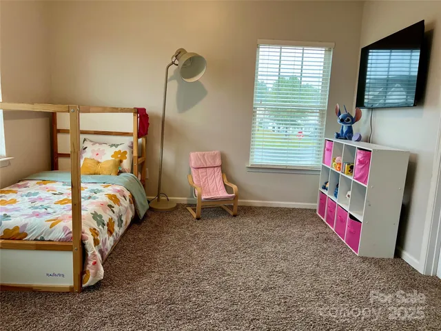 a bedroom with bed and a window