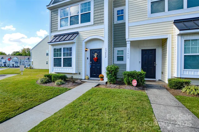 a view of a house with a yard and plants