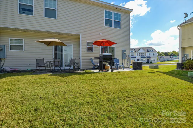 a view of a house with swimming pool and sitting area
