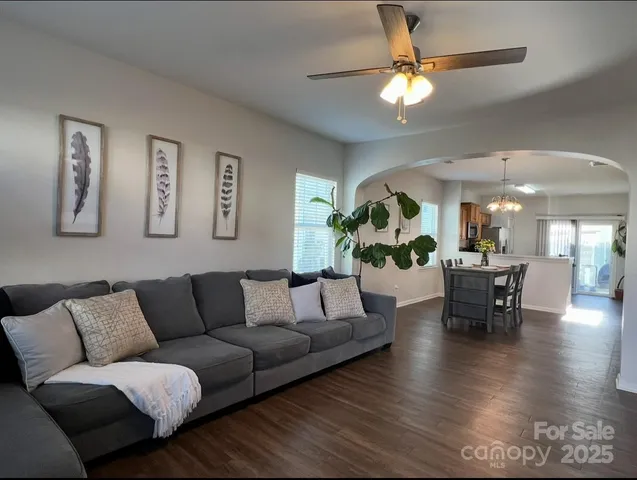 a living room with furniture and a chandelier