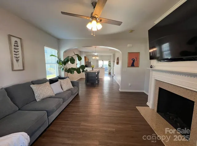 a living room with furniture fireplace and flat screen tv
