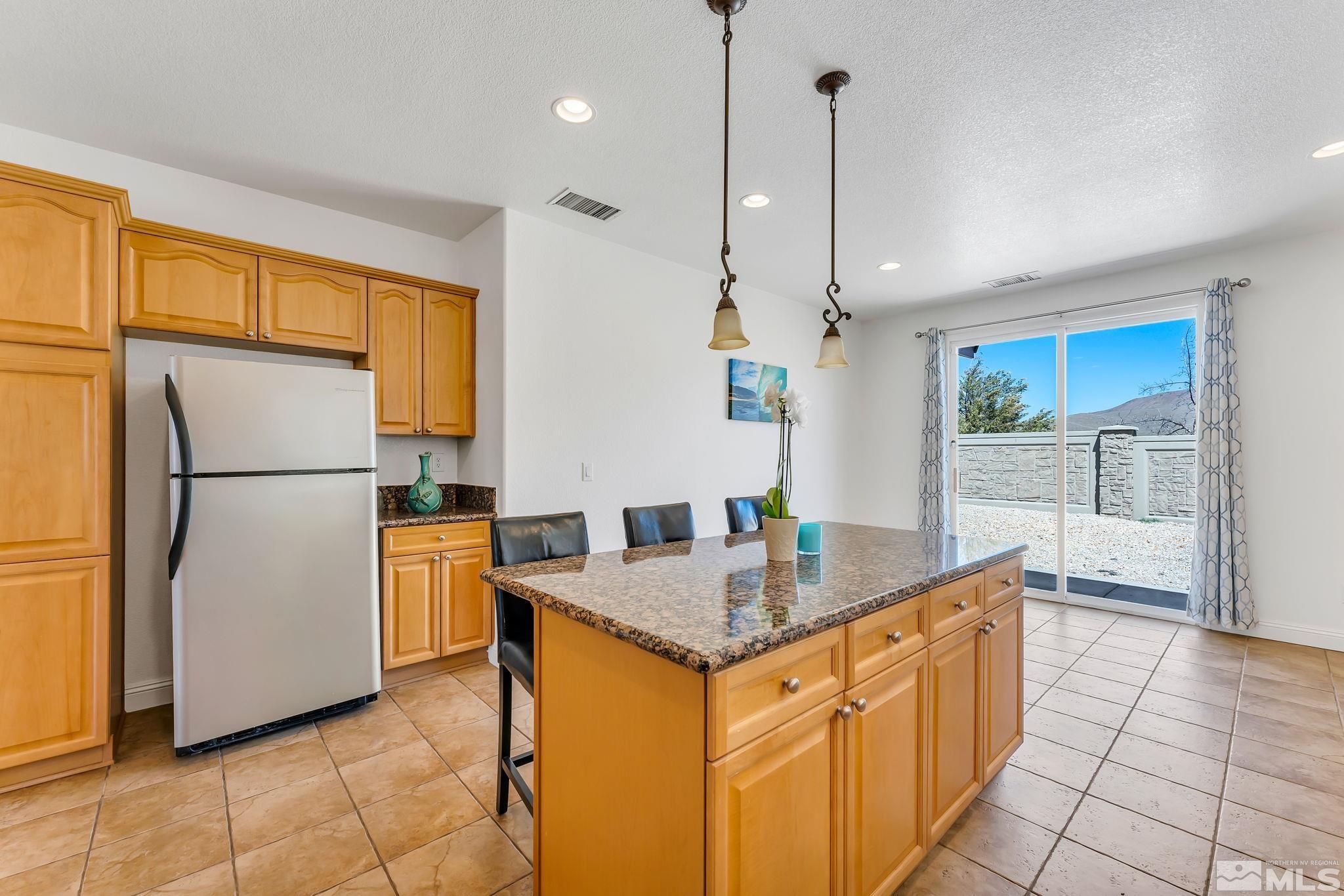 2155 Angel Ridge Drive Reno, NV 89521 - Photo 7 of 31 a kitchen with stainless steel appliances granite countertop a refrigerator a oven and a sink with granite countertops