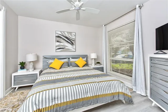 a view of a bedroom with a bed and a chandelier