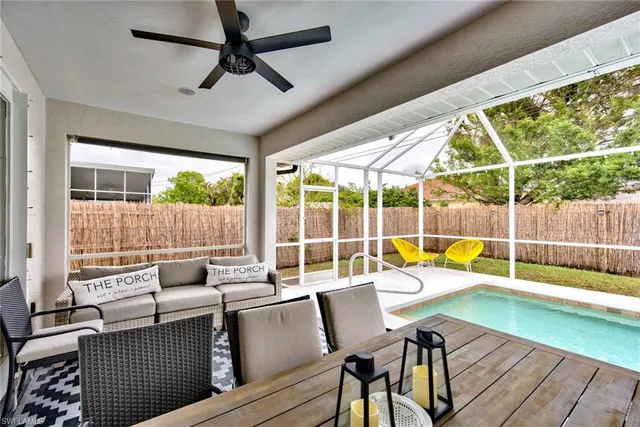 a living room with furniture and floor to ceiling windows