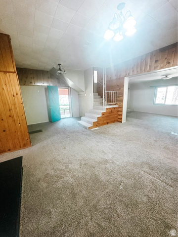 393 Old Mill Road Glenwood, UT 84730 - Photo 5 of 10 Central living area featuring light-toned carpeting and wood-paneled walls
