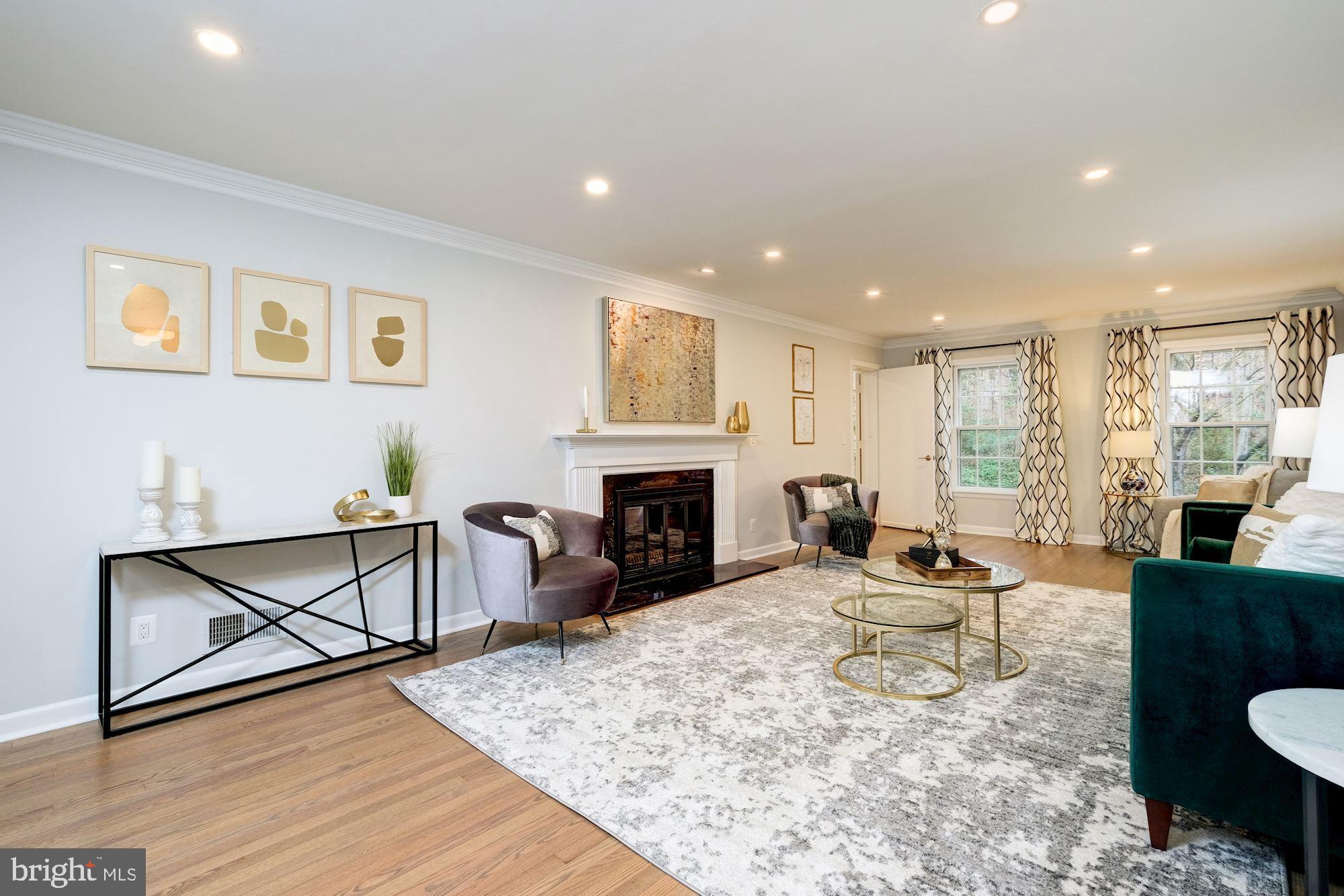 7440 Arrowood Road Bethesda, MD 20817 - Photo 11 of 79 a living room with furniture a fireplace and a table