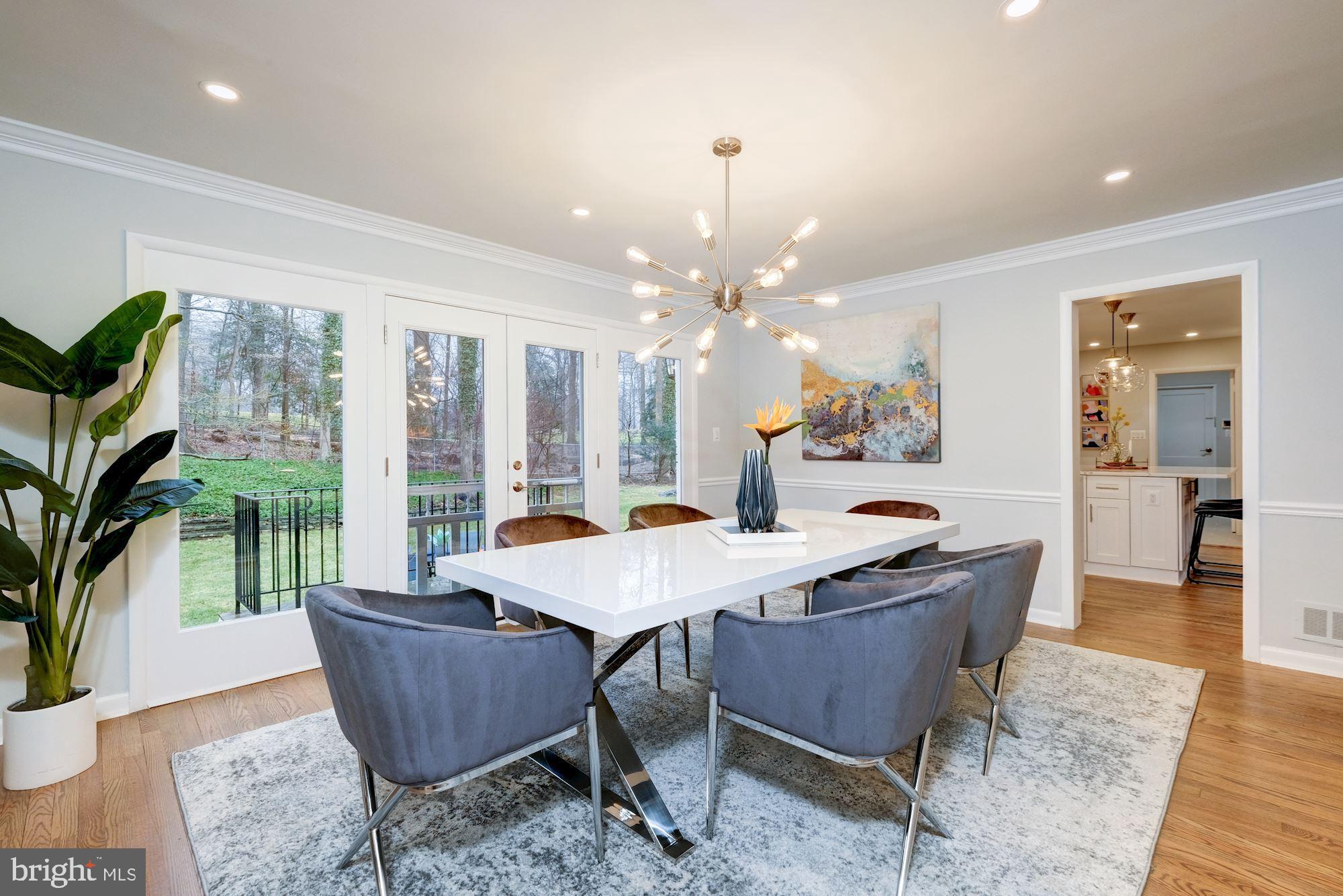 7440 Arrowood Road Bethesda, MD 20817 - Photo 18 of 79 a dining room with furniture a rug and a chandelier