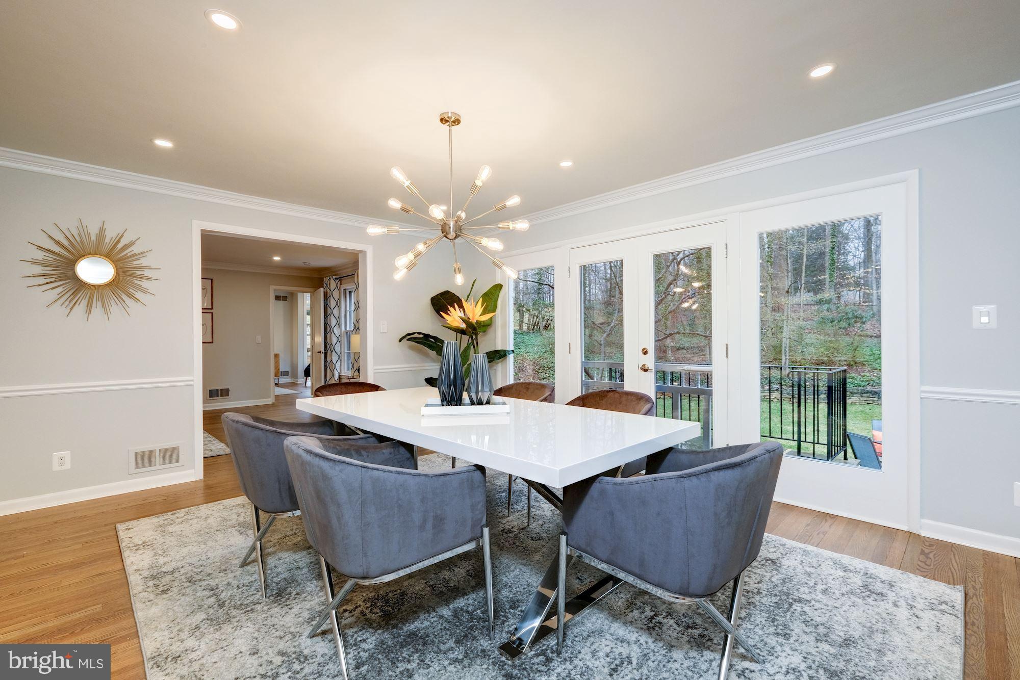 7440 Arrowood Road Bethesda, MD 20817 - Photo 19 of 79 a dining room with furniture a rug and a chandelier