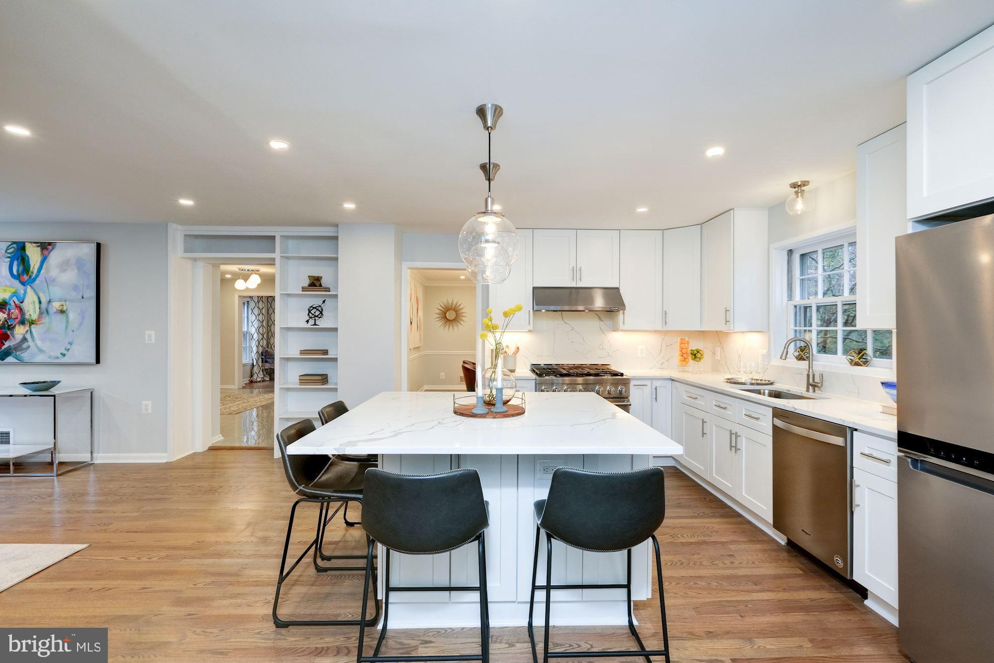 7440 Arrowood Road Bethesda, MD 20817 - Photo 24 of 79 a kitchen with stainless steel appliances granite countertop a table chairs sink refrigerator and cabinets
