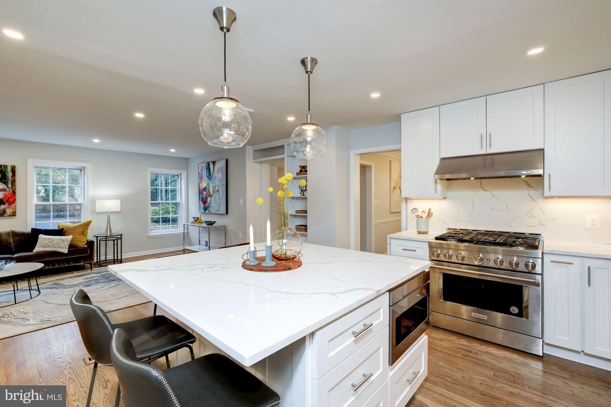 7440 Arrowood Road Bethesda, MD 20817 - Photo 25 of 79 a kitchen with a stove a table and chairs in it