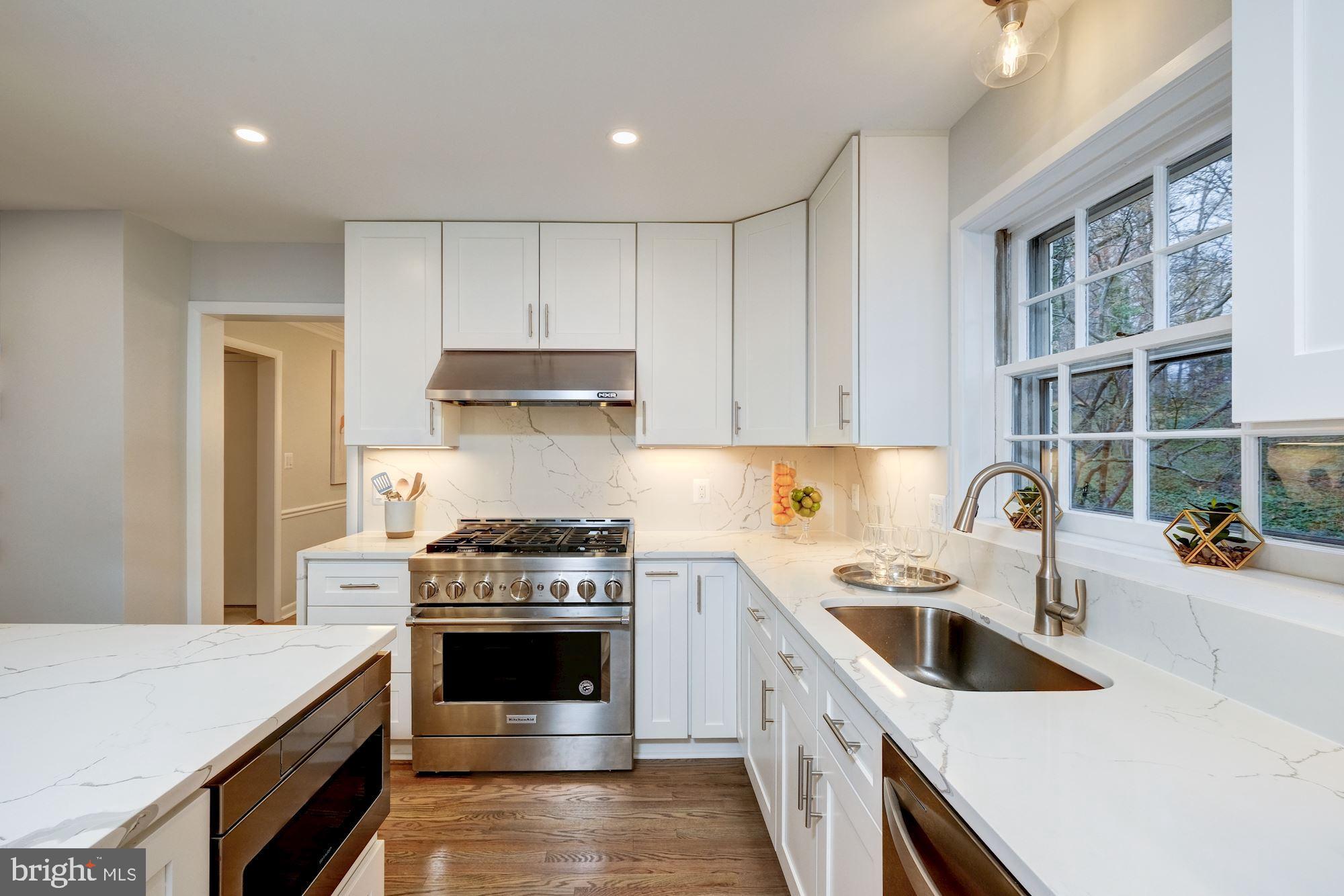 7440 Arrowood Road Bethesda, MD 20817 - Photo 26 of 79 a kitchen with a stove sink and cabinets